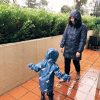 Jumping in the rain - mother and daughter